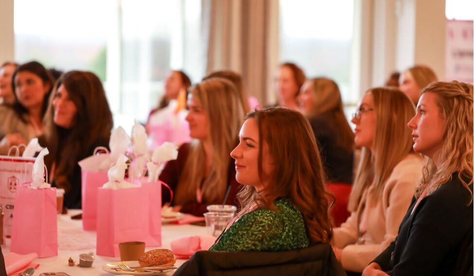 Attendees networking around the event tables
