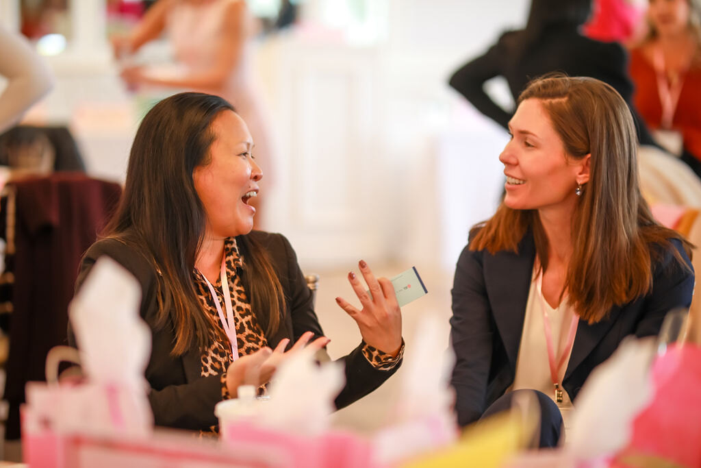 Guests in conversation around a networking table
